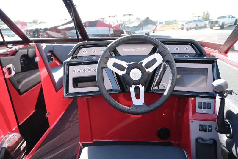 Slide: The Image of 2026 MasterCraft NXT22 boat dashboard with modern steering wheel and digital controls. - 16
