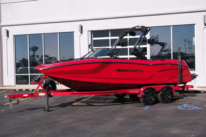 Slide: The Image of 2026 MasterCraft NXT22 boat in vibrant red on a matching trailer. - 2