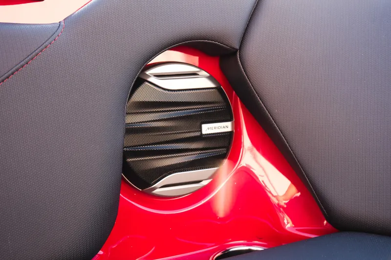 Slide: The Image of Speaker detail in 2026 MasterCraft NXT22 boat with red and black interior. - 21