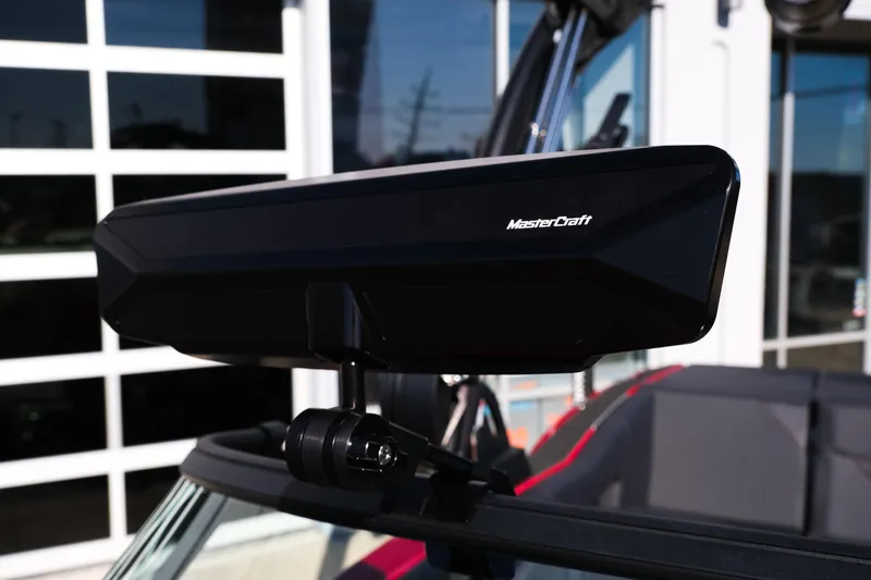 Slide: The Image of 2026 MasterCraft NXT22 boat rearview mirror close-up in sunlight. - 27