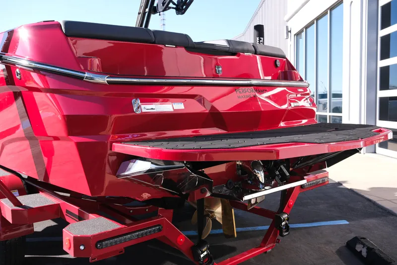 Slide: The Image of 2026 MasterCraft NXT22 boat in vibrant red, rear view with swim platform. - 5