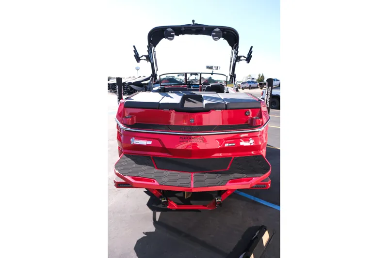 Slide: The Image of 2026 MasterCraft NXT22 boat, rear view, vibrant red color, parked outdoors. - 6