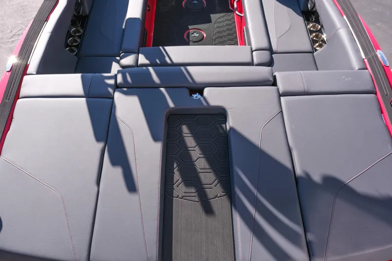 Slide: The Image of 2026 MasterCraft NXT22 boat interior with gray seating and red accents. - 9