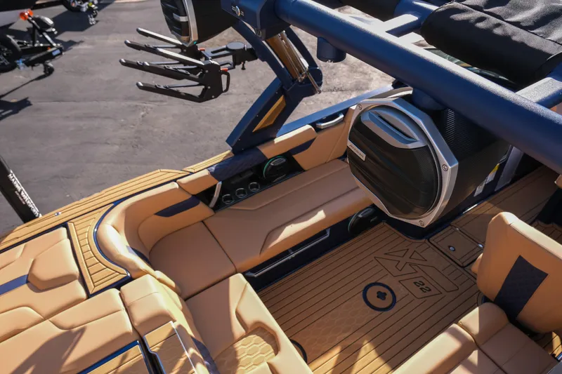 Slide: The Image of 2026 MasterCraft XT22 boat interior with tan seating and advanced audio system. - 11