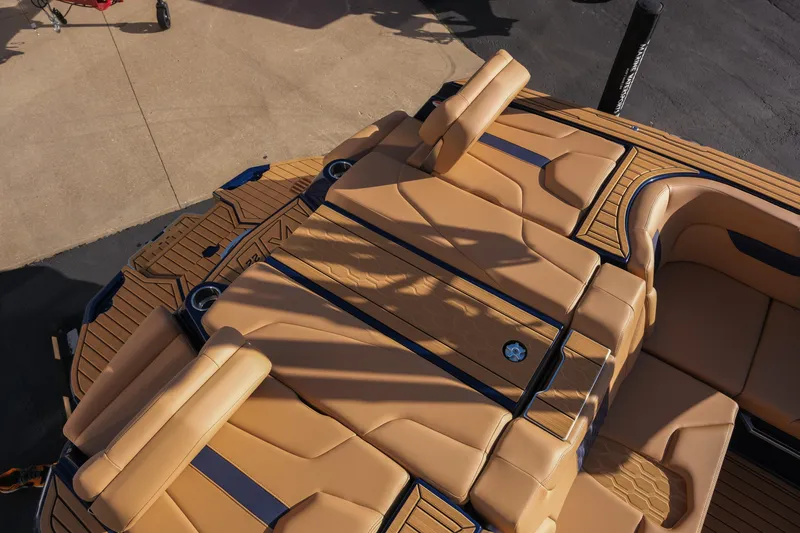 Slide: The Image of 2026 MasterCraft XT22 boat interior with tan upholstery and sleek design. - 12