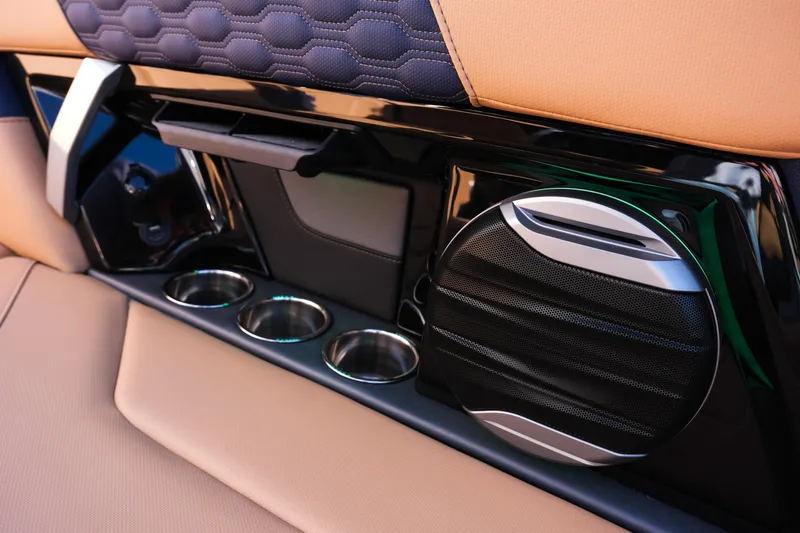 Slide: The Image of Interior of 2026 MasterCraft XT22 boat featuring speaker and cup holders. - 17