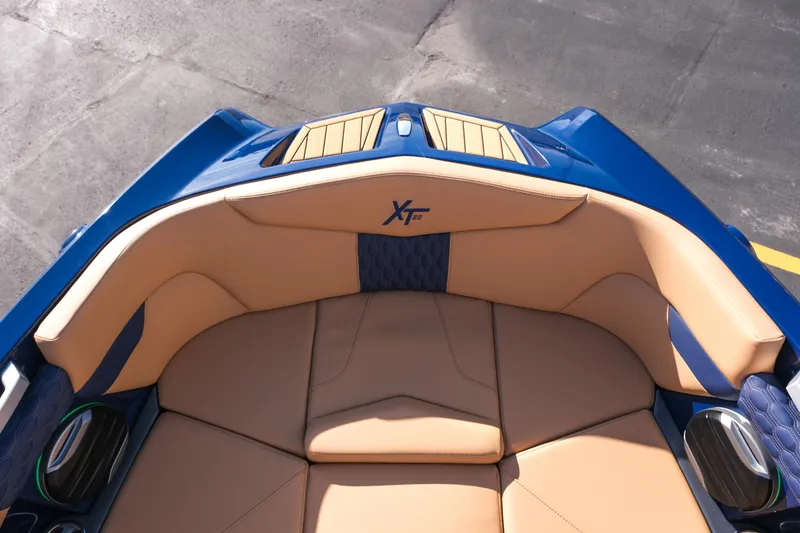 Slide: The Image of 2026 MasterCraft XT22 boat interior with tan and blue seating, showcasing luxury design. - 21