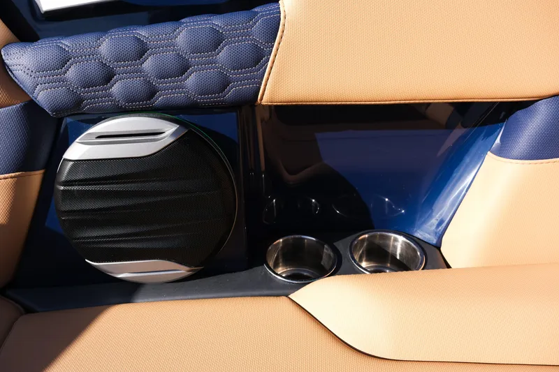 Slide: The Image of 2026 MasterCraft XT22 interior with speaker, cup holders, and stylish upholstery. - 23