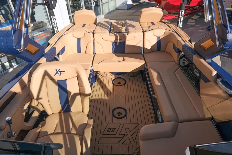 Slide: The Image of 2026 MasterCraft XT22 boat interior with tan and blue seating, showcasing luxury design. - 24