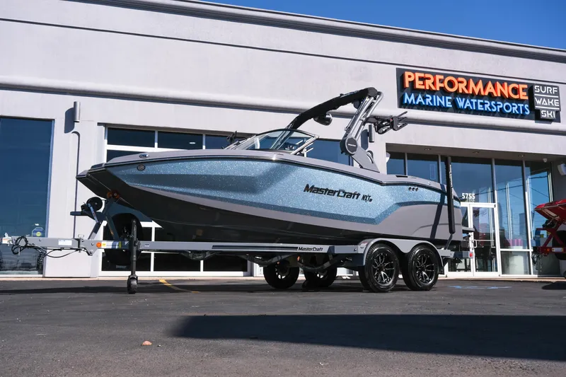 The Image of 2026 MasterCraft NXT20 boat on trailer at Performance Marine Watersports dealership. - 1