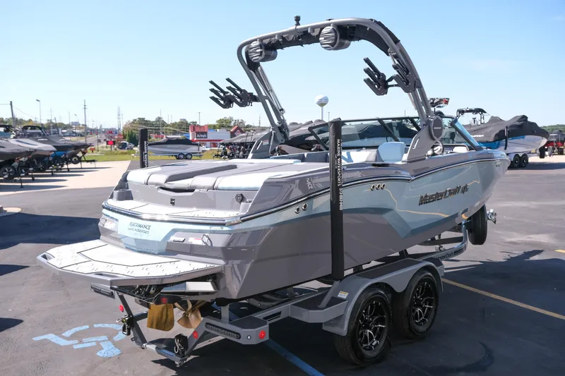 Slide: The Image of 2026 MasterCraft NXT20 boat on trailer in dealership lot, rear view. - 8