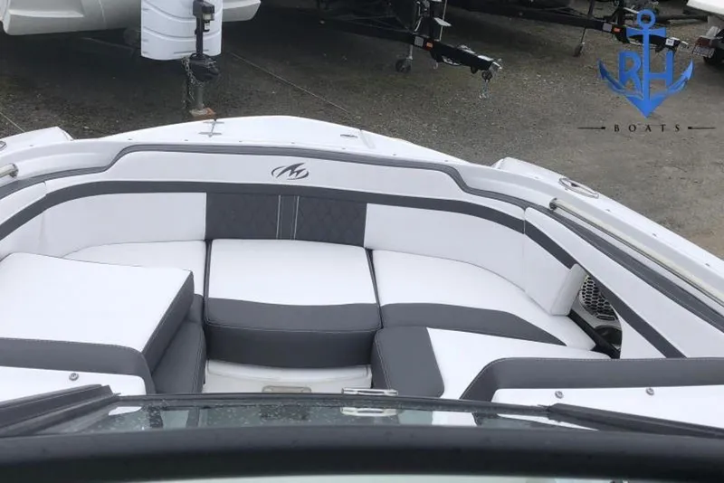 Slide: The Image of 2022 Monterey M4 boat interior with white and gray seating, parked on a trailer. - 4