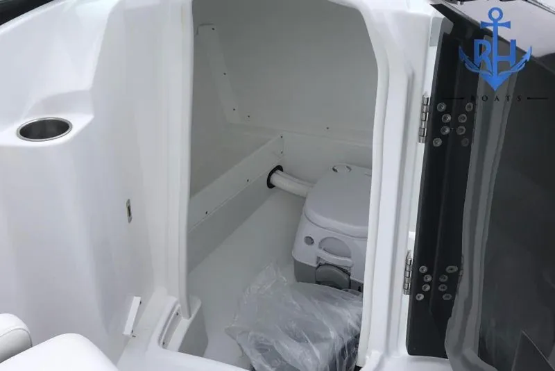 Slide: The Image of Interior of a 2022 Monterey M4 boat featuring a compact marine toilet. - 5