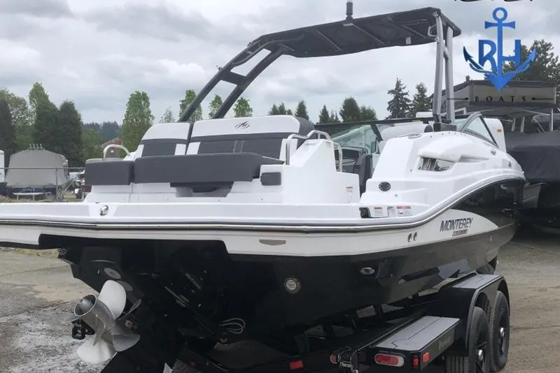 Slide: The Image of 2022 Monterey M4 boat on trailer, black and white design, outdoor setting. - 6