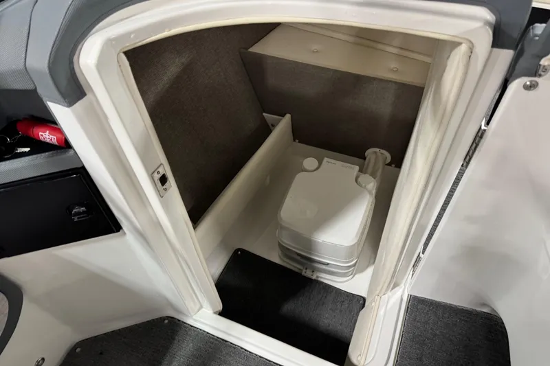 Slide: The Image of 2018 Cobalt R5 Surf boat interior with compact portable toilet. - 12