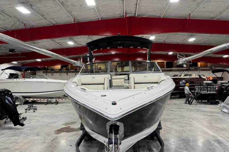 Slide: The Image of 2018 Cobalt R5 Surf boat displayed in a spacious indoor showroom. - 5