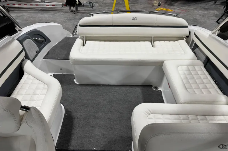 Slide: The Image of 2018 Cobalt R5 Surf boat interior with white cushioned seating and gray carpet. - 9