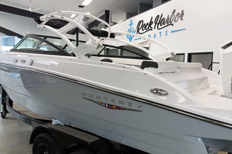 Slide: The Image of 2025 Monterey M-225 boat displayed at Rock Harbor Boats showroom. - 2