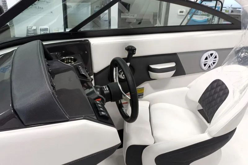 Slide: The Image of 2025 Monterey M-225 boat interior with steering wheel and modern seating design. - 5