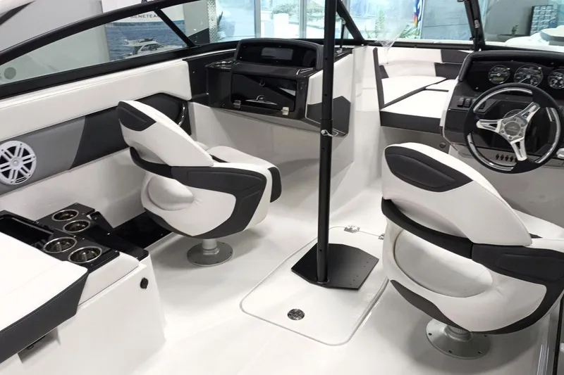 Slide: The Image of 2025 Monterey M-225 boat interior with modern seating, steering wheel, and cup holders. - 6