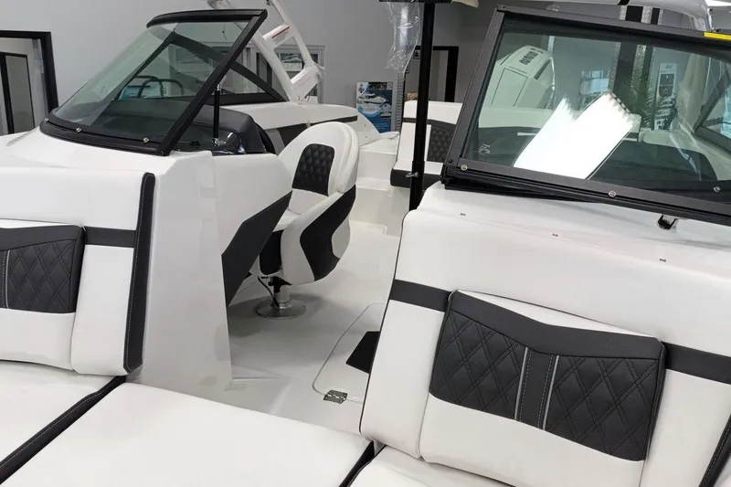 Slide: The Image of 2025 Monterey M-225 boat interior with sleek black and white seating design. - 7
