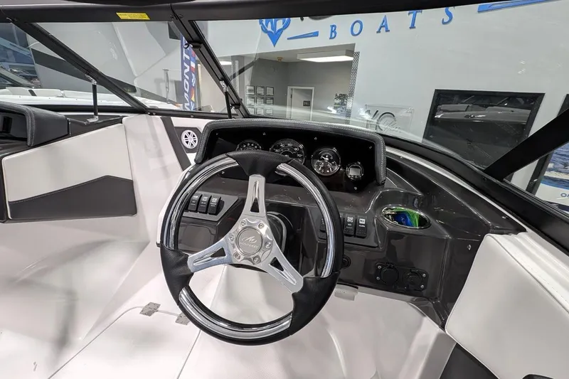 Slide: The Image of Interior view of 2025 Monterey M-205 boat dashboard with steering wheel and controls. - 8