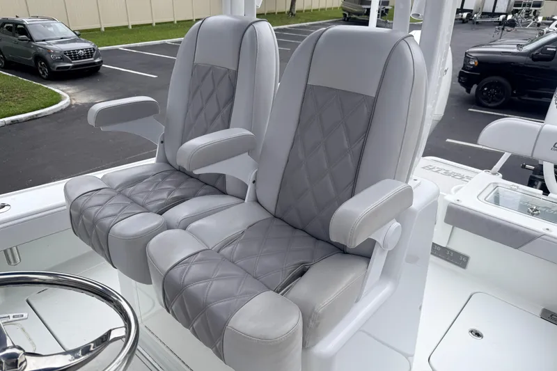 Slide: The Image of Luxurious seating on 2022 Costa Custom Boats 264, featuring diamond-stitched gray upholstery. - 10
