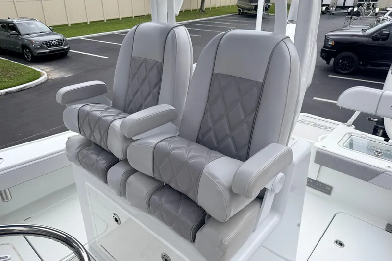 Slide: The Image of Luxury seating on 2022 Costa Custom Boats 264, featuring gray leather upholstery and armrests. - 11