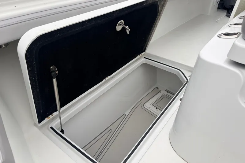 Slide: The Image of Open storage compartment on 2022 Costa Custom Boats 264, showcasing interior space and design. - 19