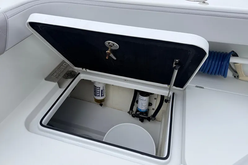 Slide: The Image of Open storage compartment on a 2022 Costa Custom Boats 264, showing internal components. - 20