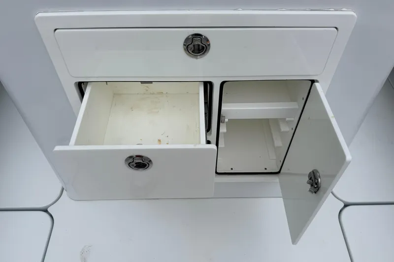 Slide: The Image of Open storage compartments on a 2022 Costa Custom Boats 264. - 22