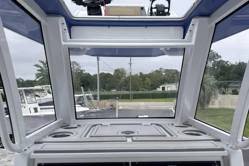 Slide: The Image of Interior view of 2022 Costa Custom Boats 264, showcasing helm and windshield. - 24