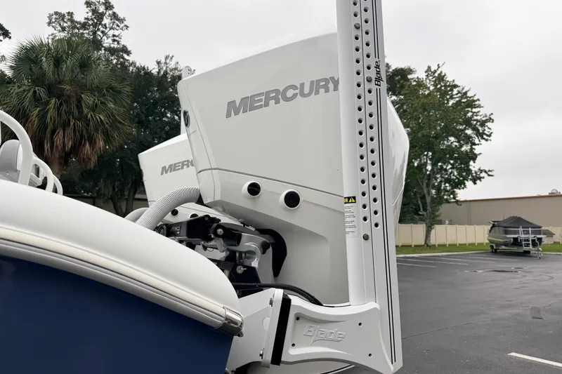 Slide: The Image of 2022 Costa Custom Boats 264 with Mercury outboard engine in parking lot. - 25