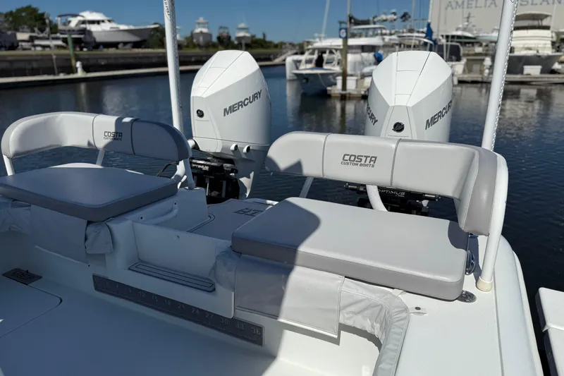 Slide: The Image of 2022 Costa Custom Boats 264 with dual Mercury engines docked at marina. - 34