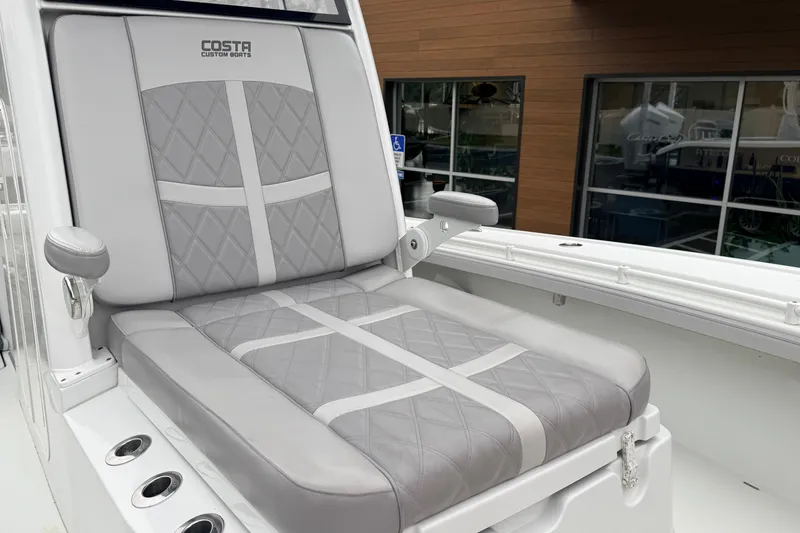 Slide: The Image of 2022 Costa Custom Boats 264 seat with gray diamond-pattern upholstery. - 6