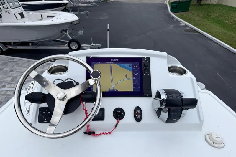 Slide: The Image of Helm of 2022 Costa Custom Boats 264 with navigation display and controls. - 8