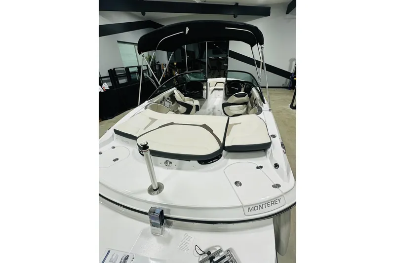 Slide: The Image of 2025 Monterey 224FS boat with sleek design and comfortable seating in showroom. - 11
