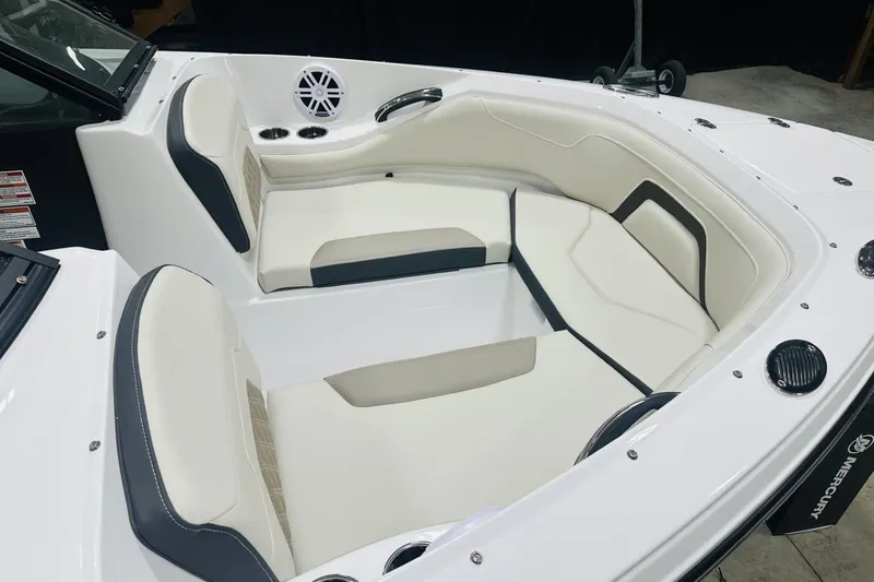 Slide: The Image of 2025 Monterey 224FS boat interior with white and black seating, cup holders, and speaker. - 14