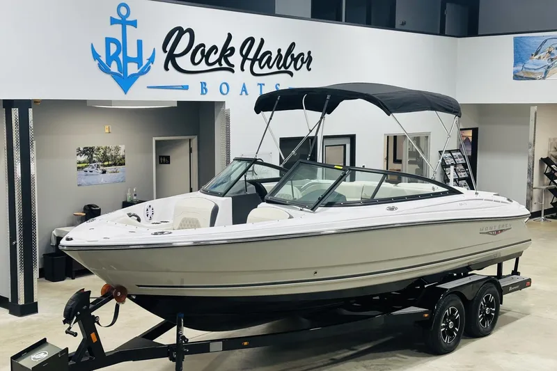Slide: The Image of 2025 Monterey 224FS boat displayed at Rock Harbor Boats showroom. - 2