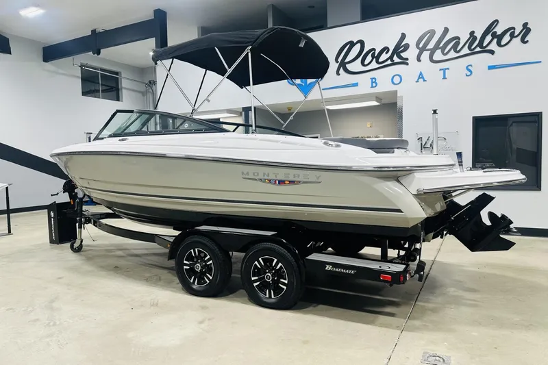 Slide: The Image of 2025 Monterey 224FS boat displayed indoors at Rock Harbor Boats showroom. - 3