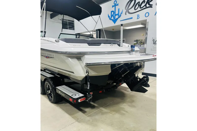 Slide: The Image of 2025 Monterey 224FS boat displayed indoors, featuring sleek design and modern features. - 5
