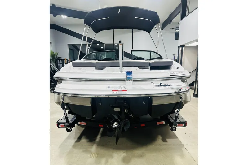 Slide: The Image of 2025 Monterey 224FS boat in showroom, rear view with canopy and trailer. - 6