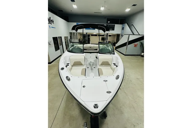 Slide: The Image of 2025 Monterey 224FS boat in showroom, featuring sleek design and spacious seating. - 7