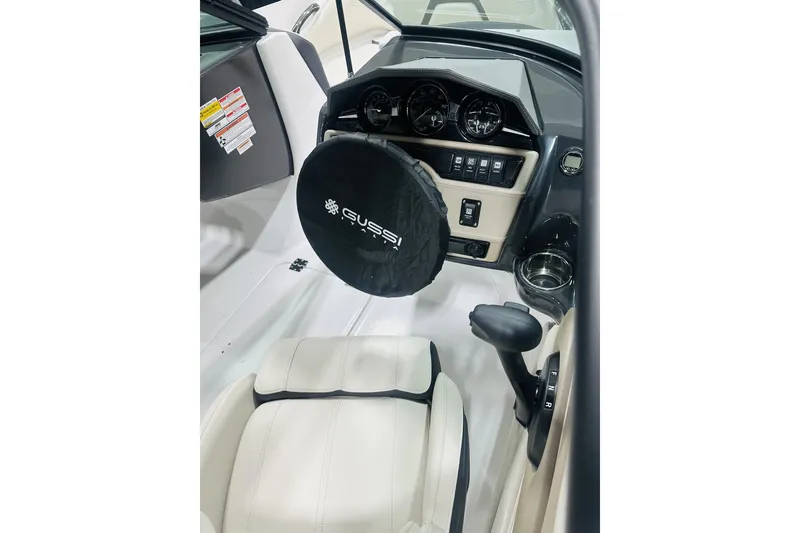 Slide: The Image of Interior of 2025 Monterey 224FS boat with steering wheel cover and dashboard controls. - 8