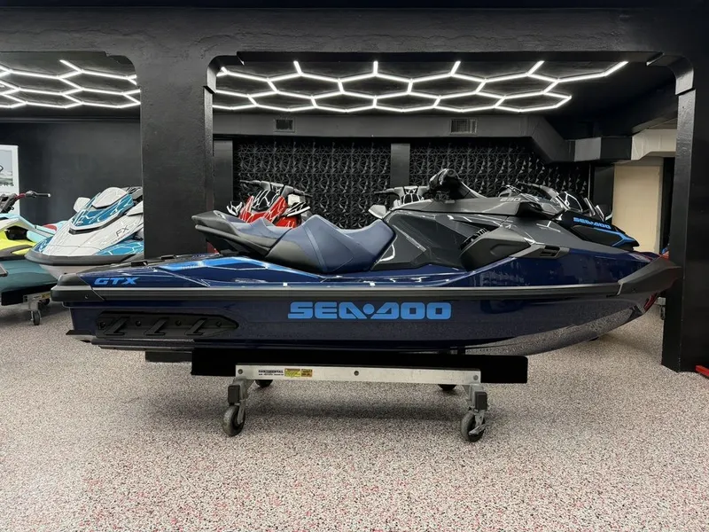 Slide: The Image of 2026 Sea-Doo GTX 230 jet ski in modern showroom. - 1