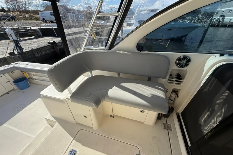 Slide: The Image of 2004 Pursuit 3100 Offshore boat interior with gray seating and storage compartments. - 11