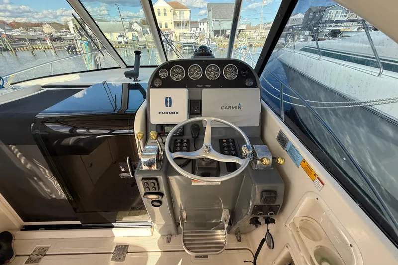 Slide: The Image of 2004 Pursuit 3100 Offshore boat helm with Garmin and Furuno navigation systems. - 13