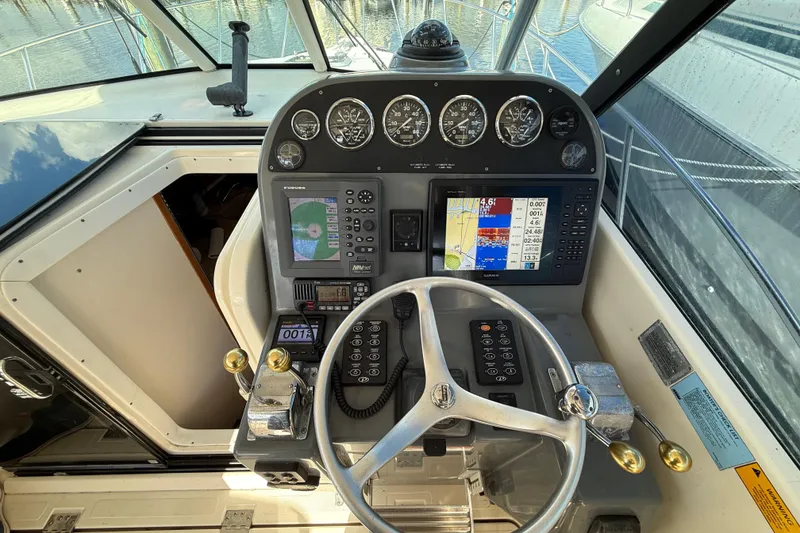 Slide: The Image of Helm of 2004 Pursuit 3100 Offshore boat with navigation instruments and steering wheel. - 16
