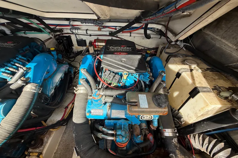 Slide: The Image of Engine compartment of a 2004 Pursuit 3100 Offshore boat, featuring Crusader engines. - 29