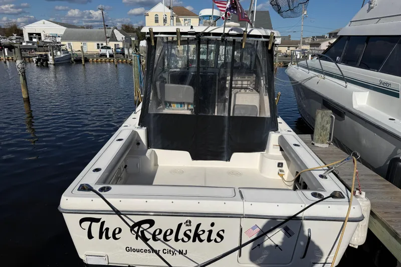 Slide: The Image of 2004 Pursuit 3100 Offshore boat docked, named "The Reelskis," in Gloucester City, NJ marina. - 3